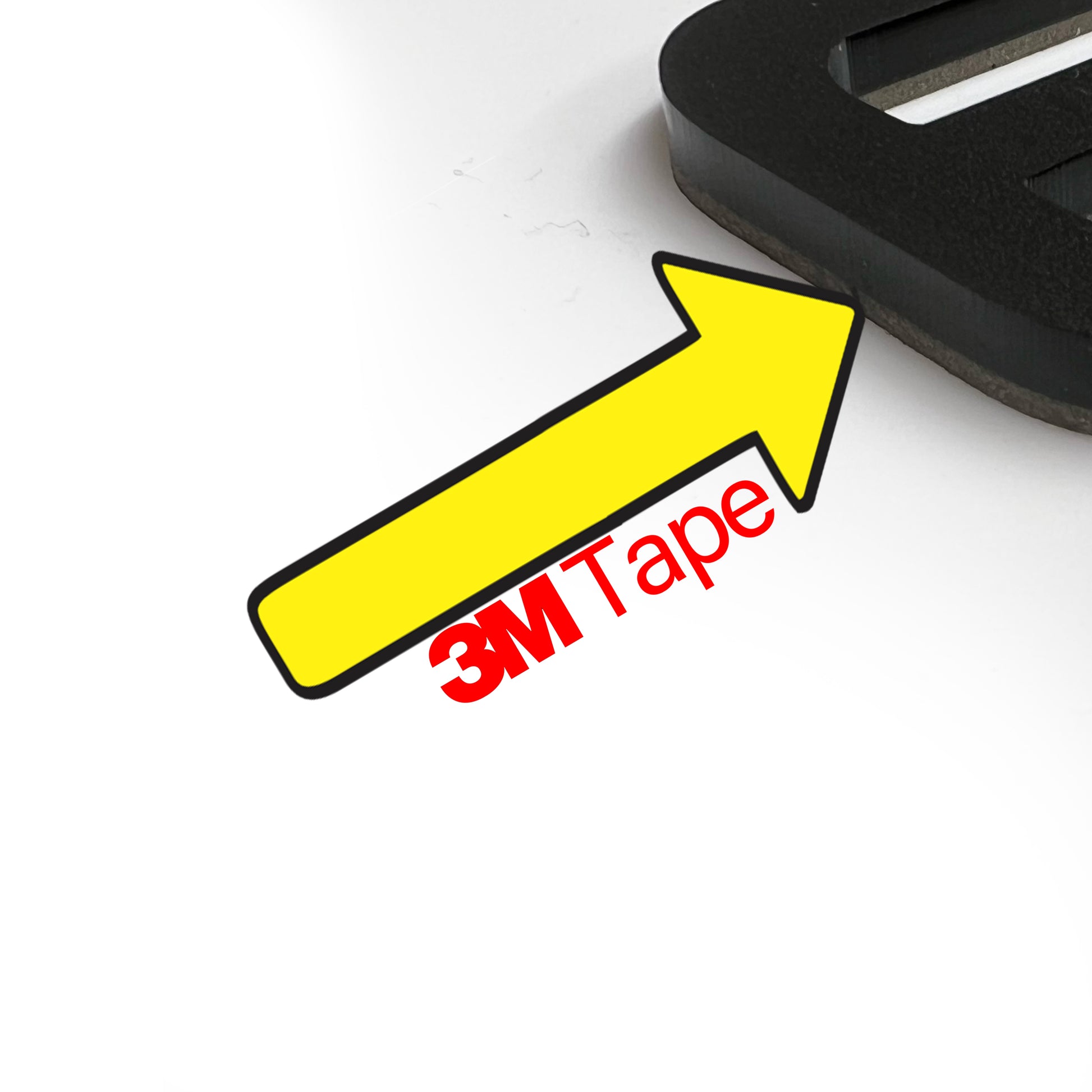 Close-up of adhesive backing detail on FMSgear Scat Pack head emblems showing 3M tape for secure attachment