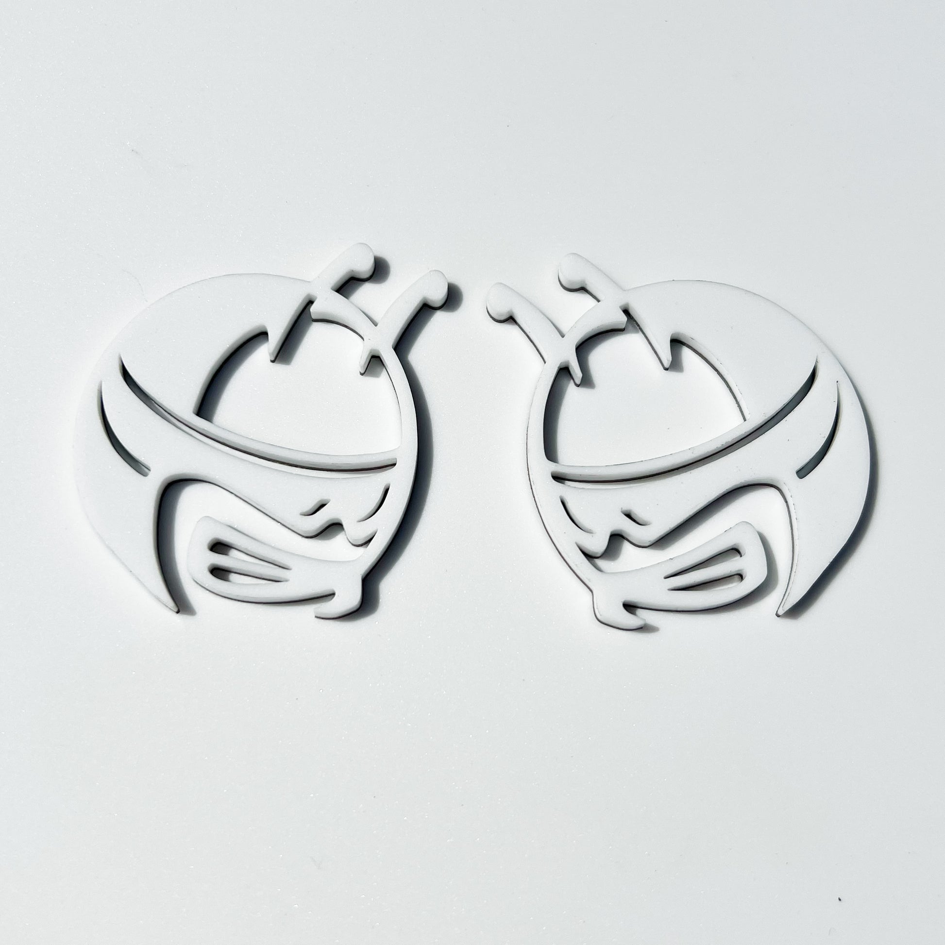 FMSgear white Scat Pack head emblems pair with detailed bug design on a plain background