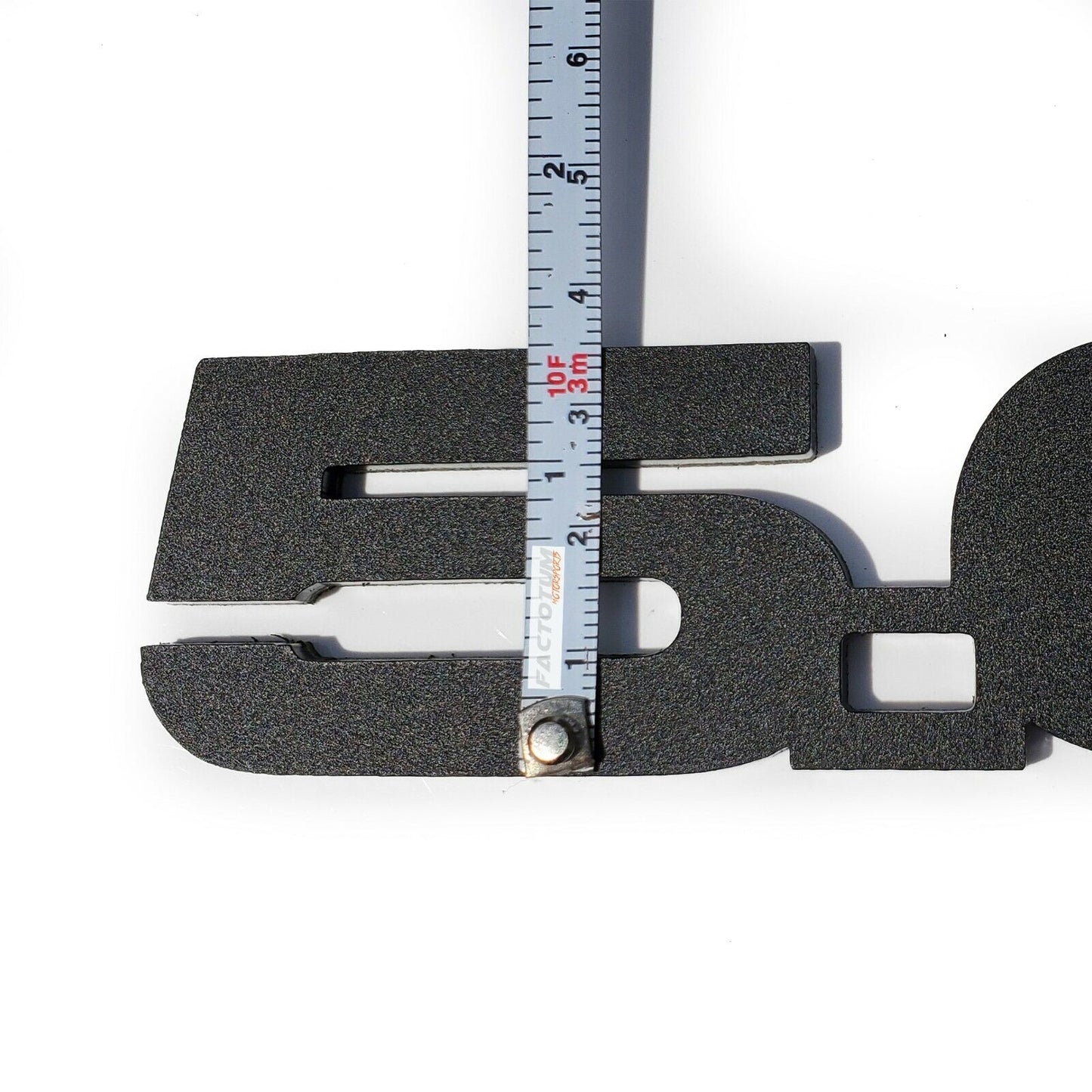Custom Ford Mustang GT 5.0 emblems with textured black finish and measuring tape showing size